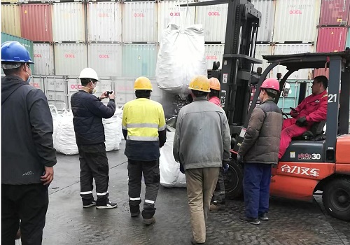 SGS inspector performing quality inspection on ferrosilicon 75 at Tianjin port before loading