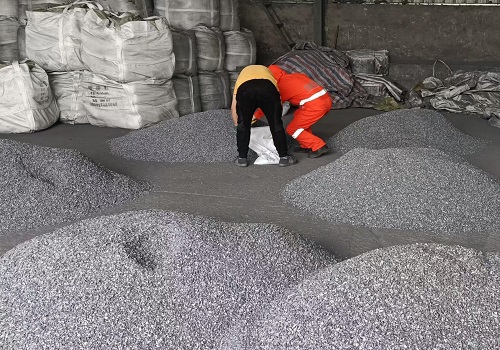 SGS inspector taking samples of FeSiBa inoculant for chemical analysis