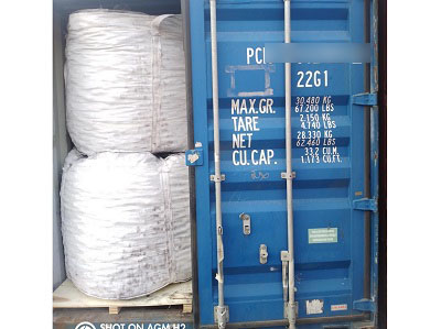 Container interior view showing white bulk bags of silicon briquette stacked on wooden pallets ready for shipment to South Asia steel plant