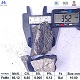 High carbon ferro manganese 65% lump with ruler for size reference and chemical specifications table, top-down view angle 2