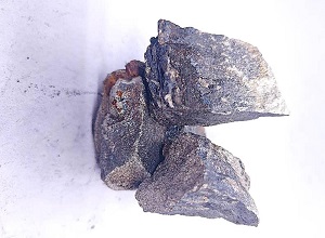 Close up appearance of mid carbon ferro manganese 78% lump showing surface texture and shape
